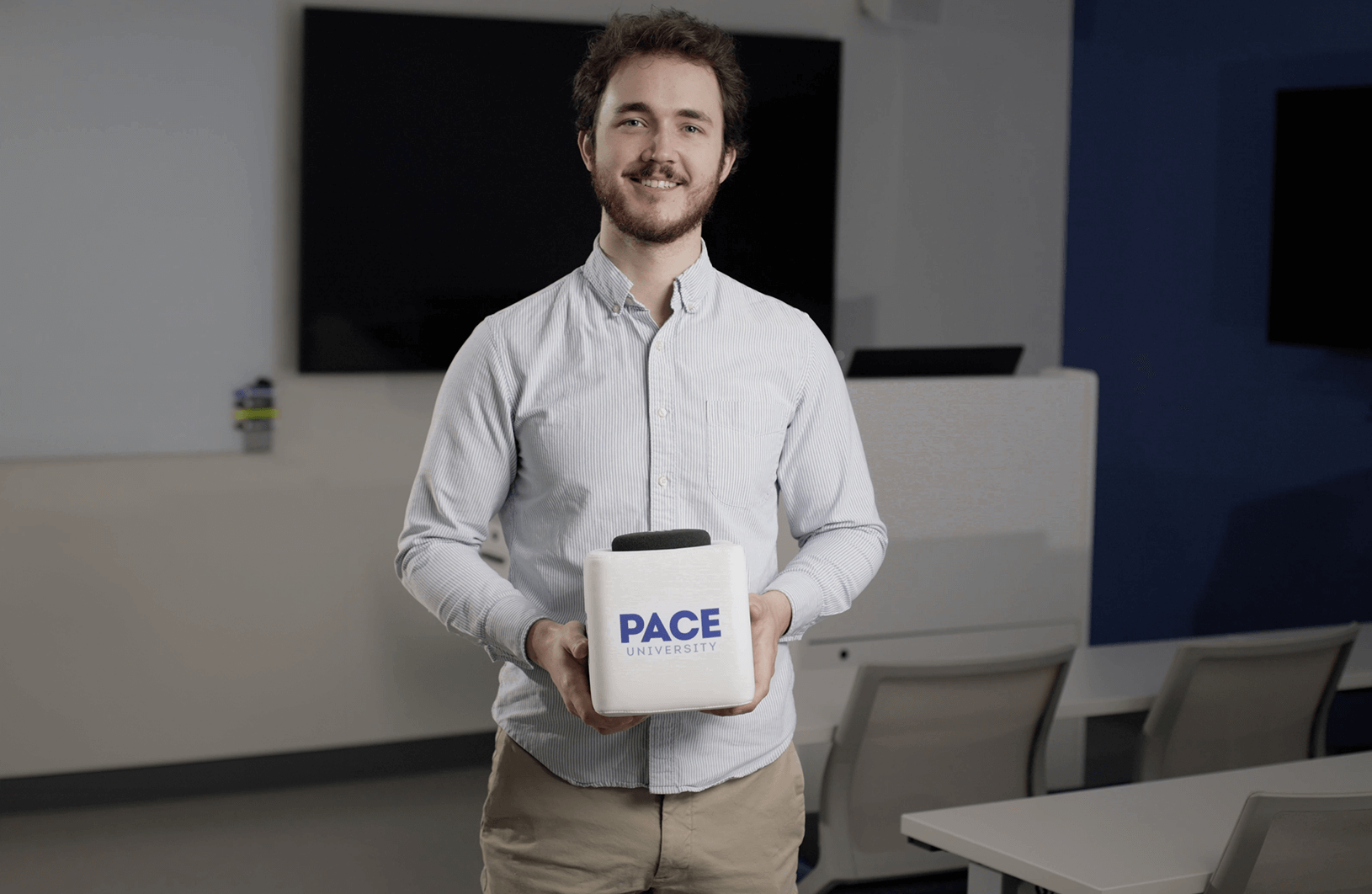 Educational media specialist Braford Terry from Pace University holding customized Catchbox Cube microphone